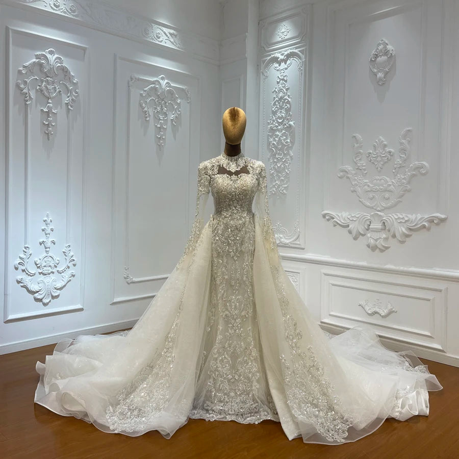 Ivory beaded lace skirt with fitted bodice and flowing tulle train