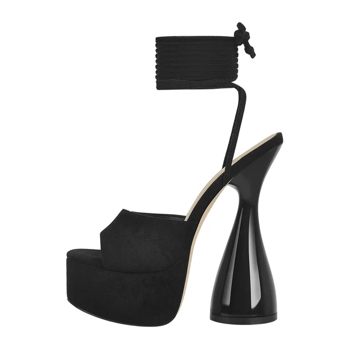 Black open-toe platform spike heel sandals with ankle wrap tie and sculpted heel.