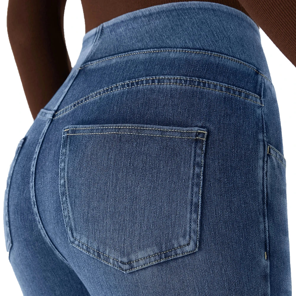 Light blue denim jeans close-up of back pocket with stitched flap detail.