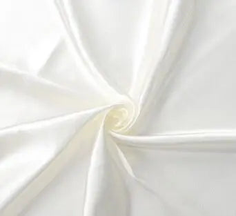 Close-up of white fabric with a swirl pattern