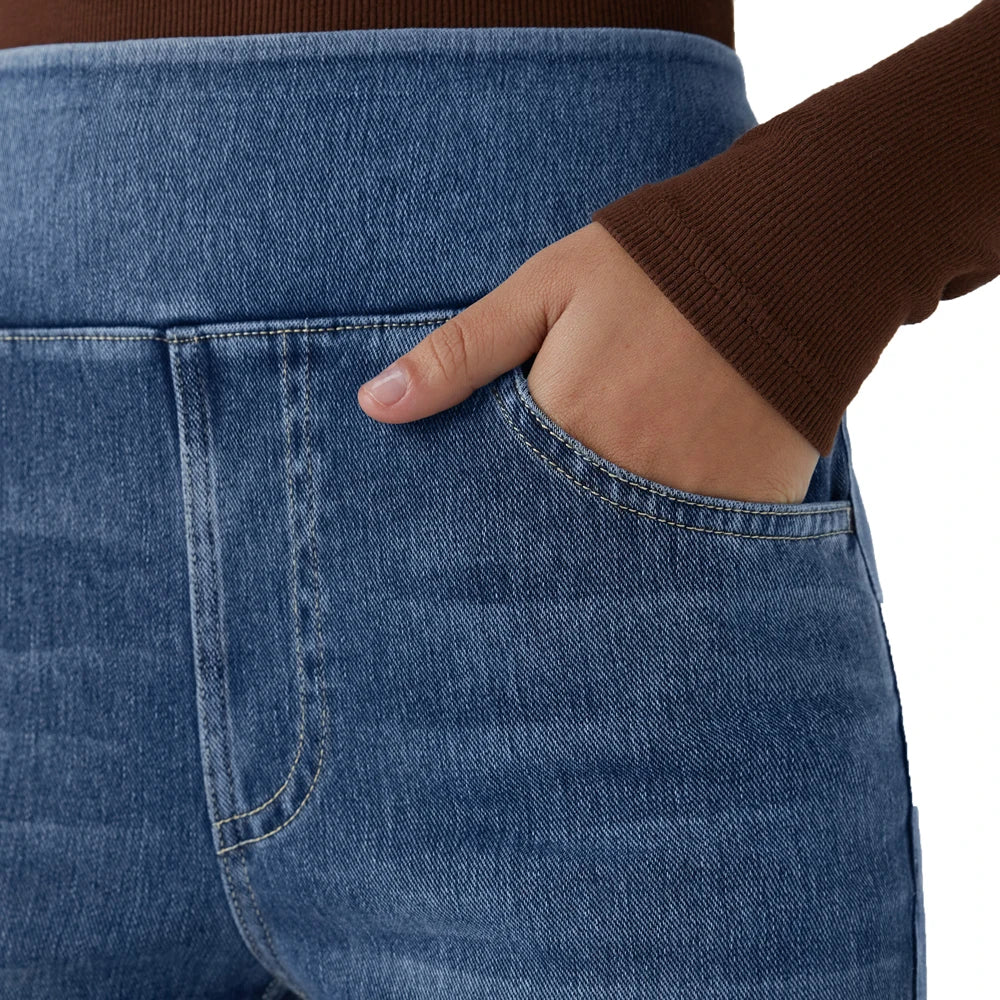 Light blue denim jeans close-up of front pocket and curved contrast stitching.