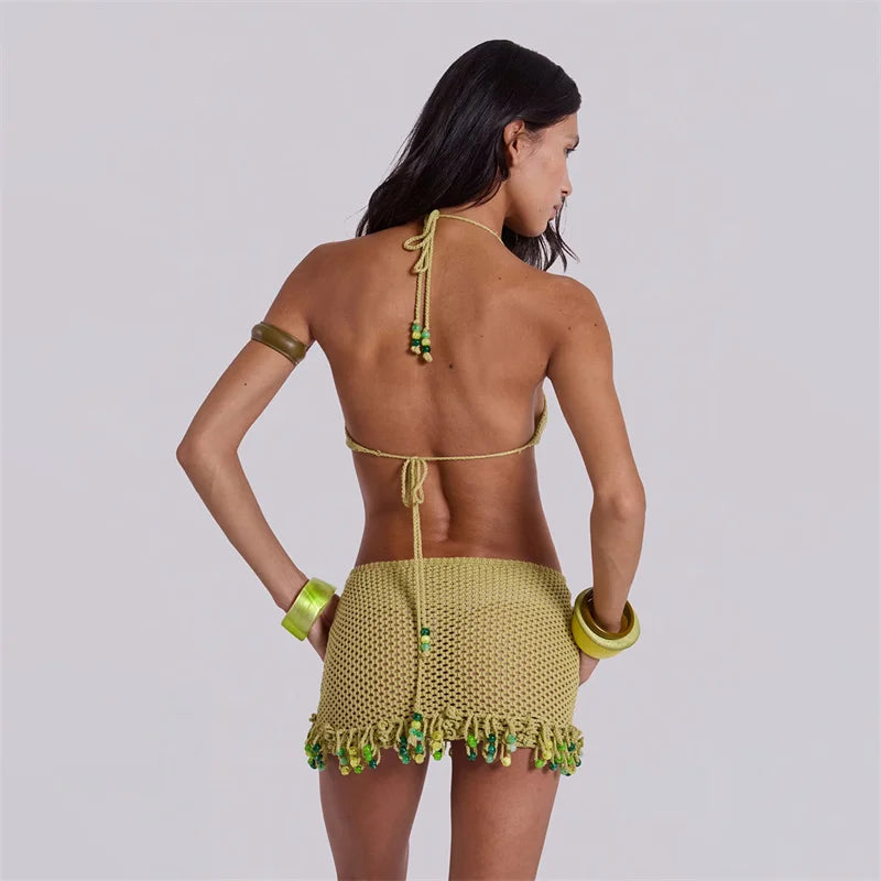 Back view of army green crochet knit bikini cover-up with crisscross tie straps