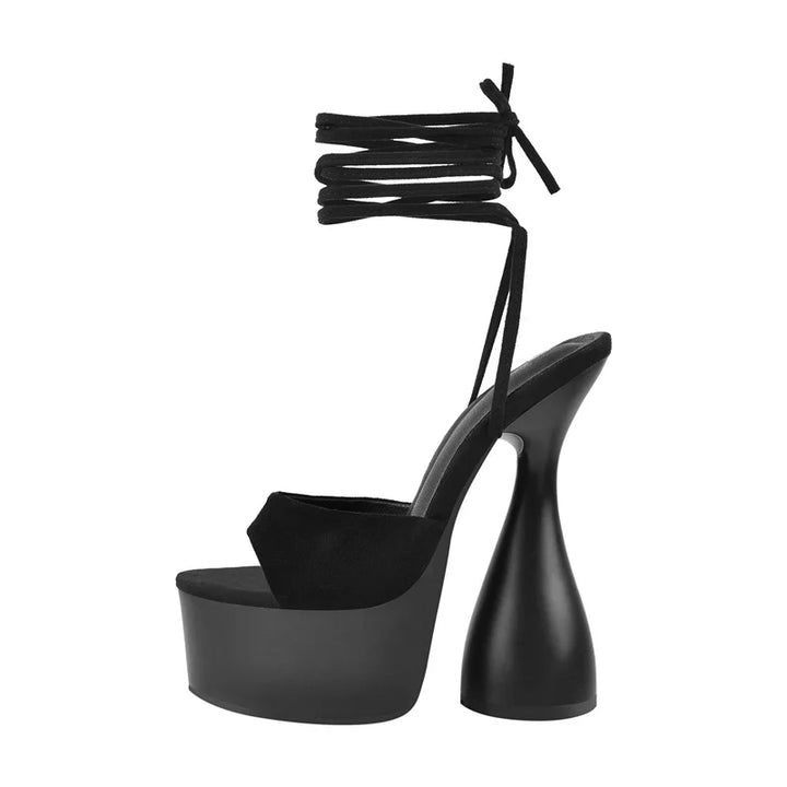 Black open-toe platform spike heel sandals with lace-up ankle tie and high spike heel.