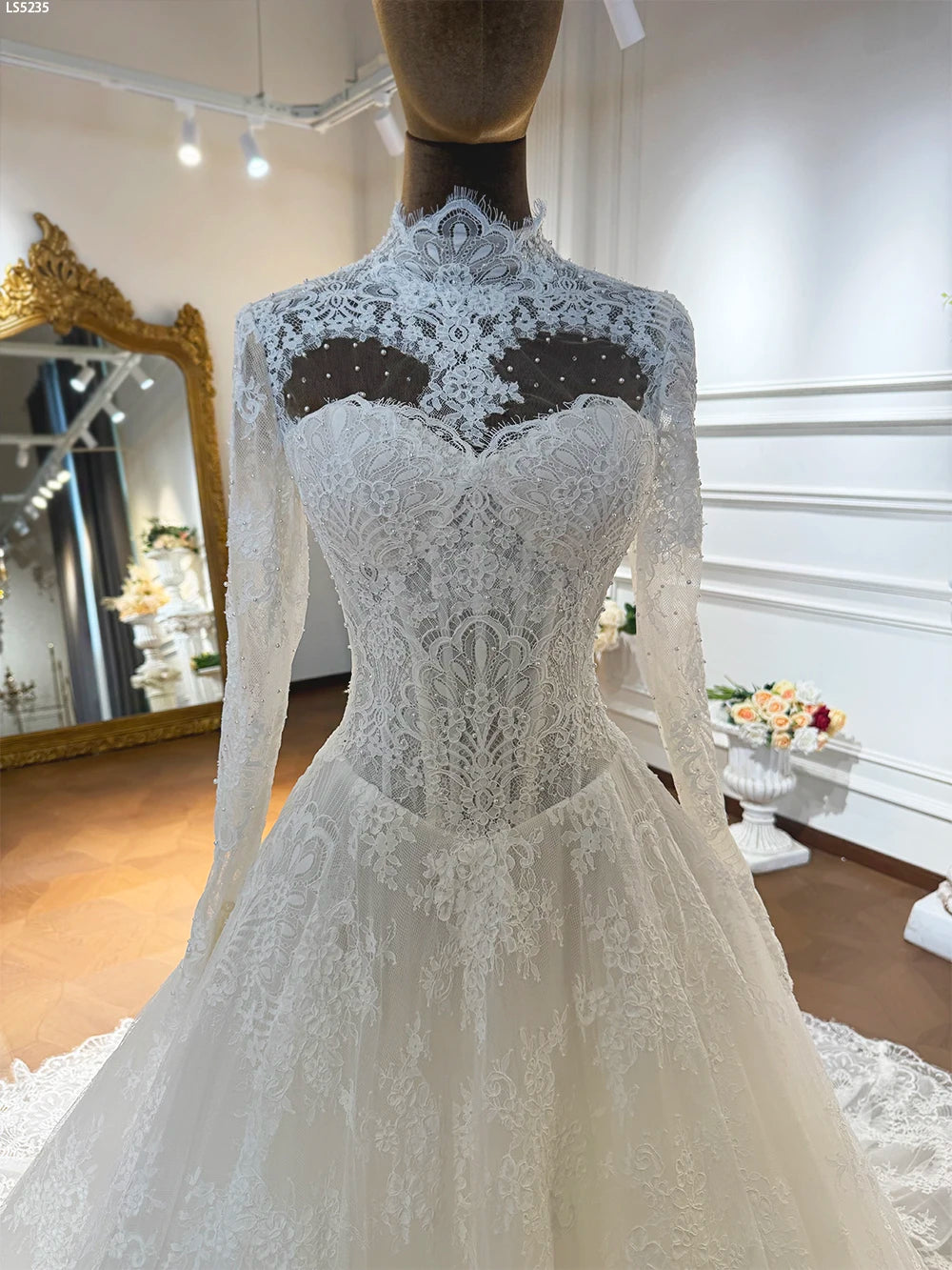 Women’s lace wedding dress bodice detail with illusion high back and lace overlay