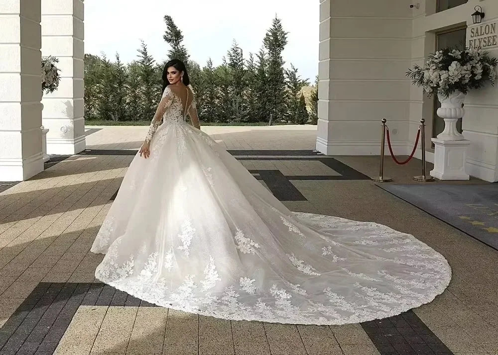 White lace bridal ball gown with long lace train and off-shoulder neckline