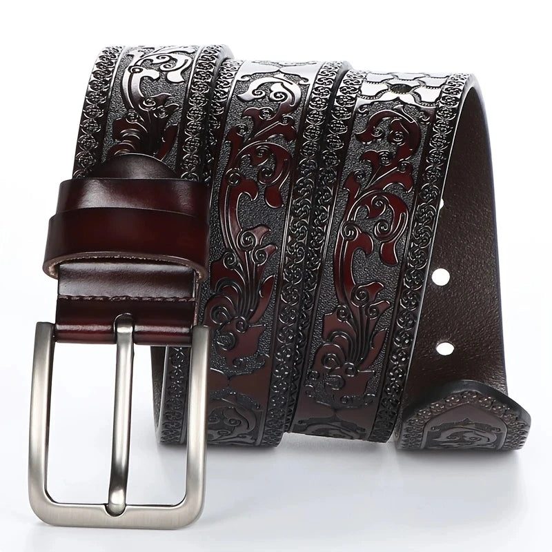 Brown leather belt with intricate silver buckle on a white background