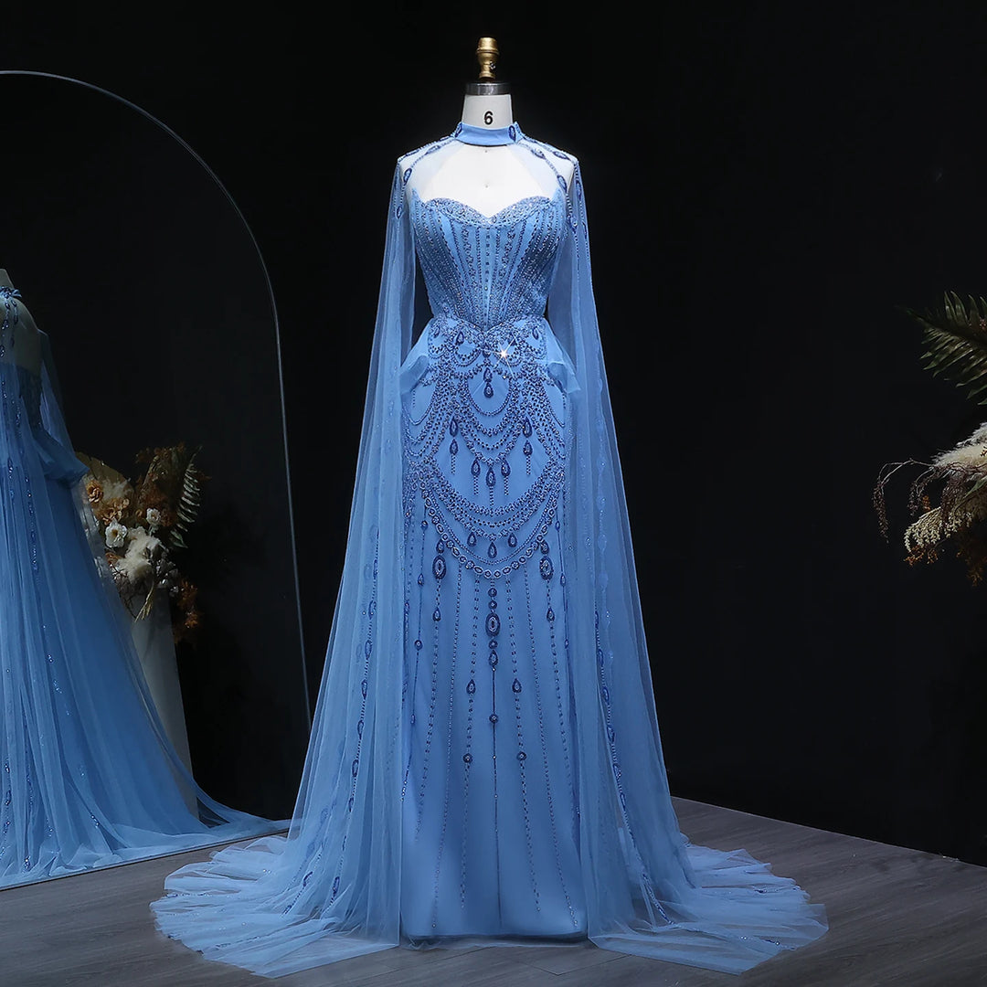 Blue evening gown with cape on a mannequin against a dark background