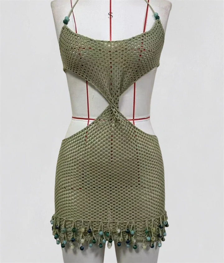 Mannequin wearing army green crochet knit bikini cover-up with crisscross back cutout