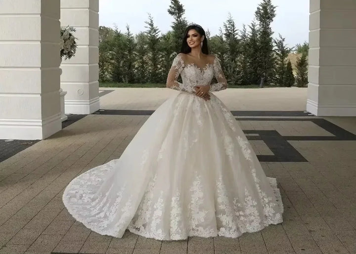 White lace bridal ball gown with off-shoulder illusion neckline and voluminous skirt