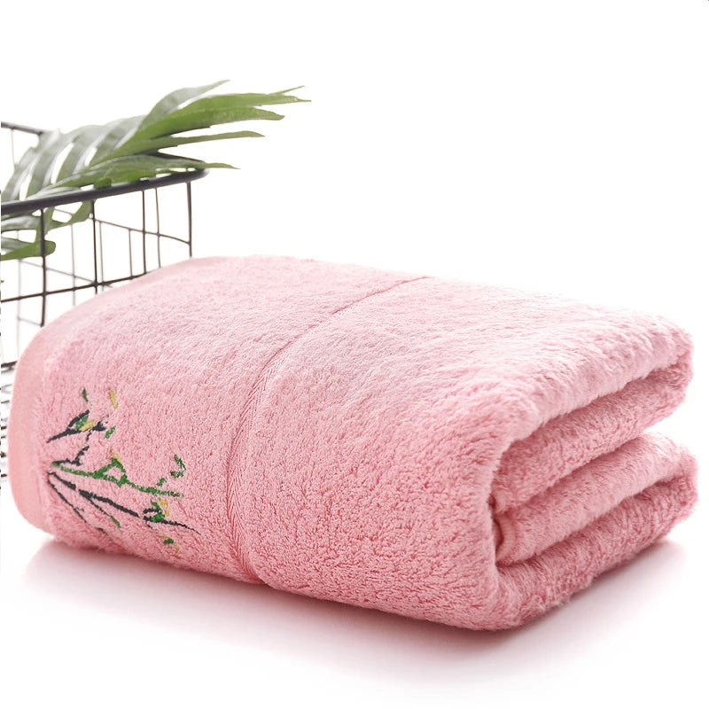 Thick bamboo-fiber bath towel set in pink, folded with embroidered bamboo leaf