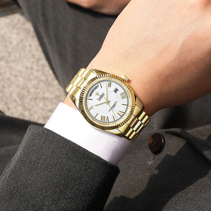 Gold-tone men’s automatic wrist watch with white dial on wrist and metal bracelet