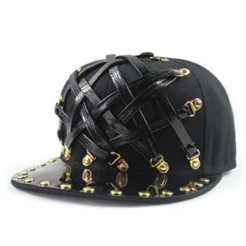 Black flat brim cap with gold-tone studs and buckle straps across crown