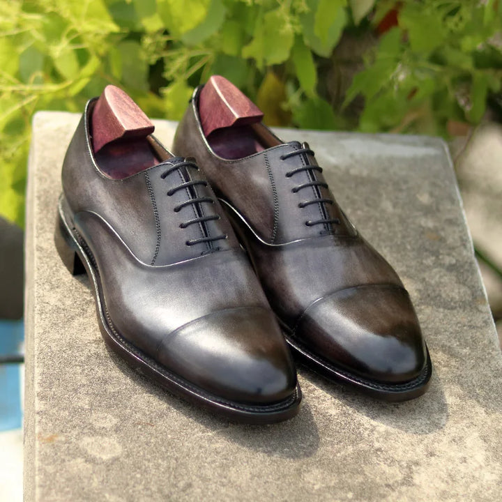 Men’s lace-up Oxford shoes with dark gray patina leather finish and stitched sole