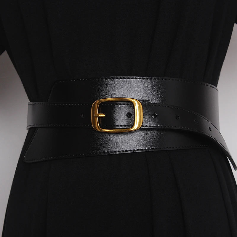 Black leather corset belt with gold-tone buckle, stitched trim and side adjustment holes