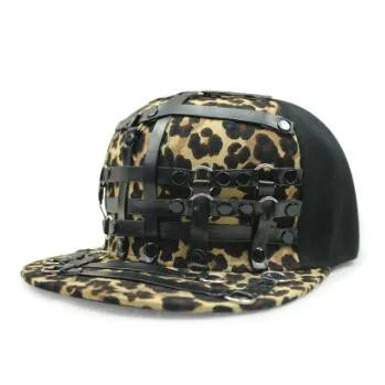 Leopard-print flat brim hat with black strap panels and metal rings and buckles
