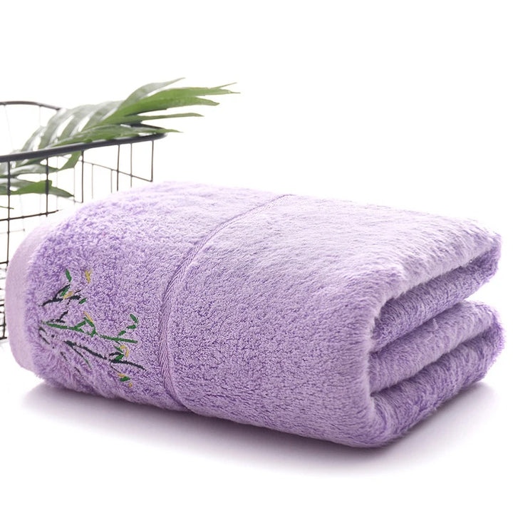 Thick bamboo-fiber bath towel set in lavender, folded with embroidered bamboo leaf