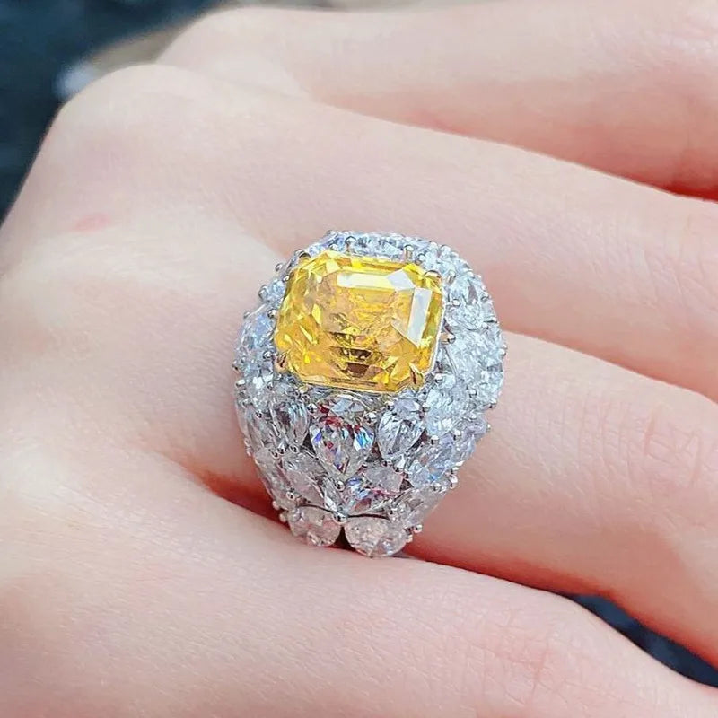 Silver-tone crystal ring with square yellow center stone and sparkling halo