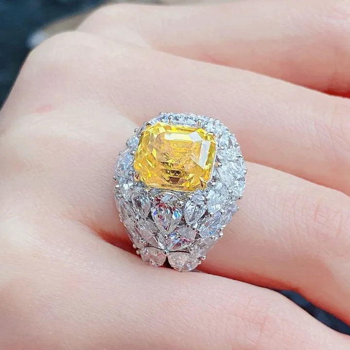 Silver-tone crystal ring with square yellow center stone and sparkling halo