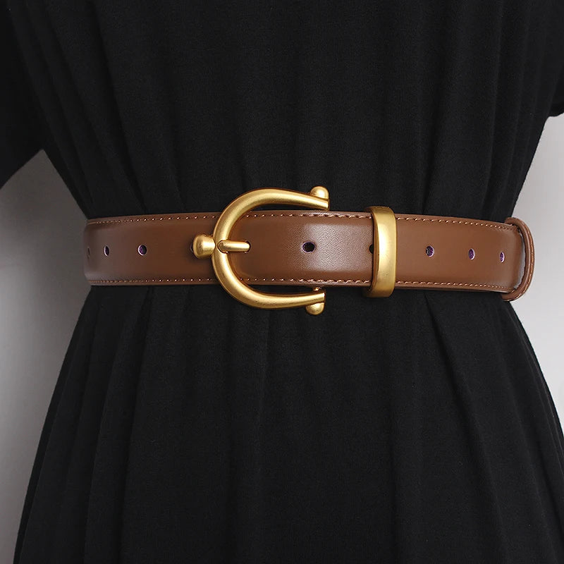 Women’s leather waist belt in brown with round gold buckle and punched adjustment holes