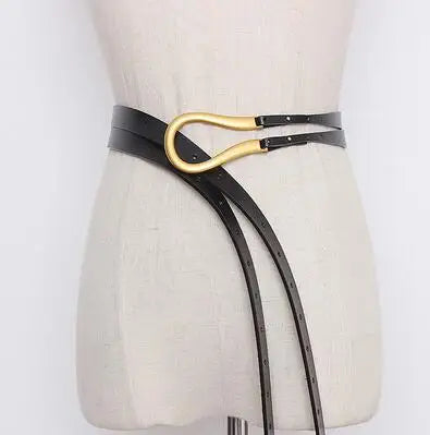 Women’s wide leather belt with oval gold buckle, black and dark trim accents
