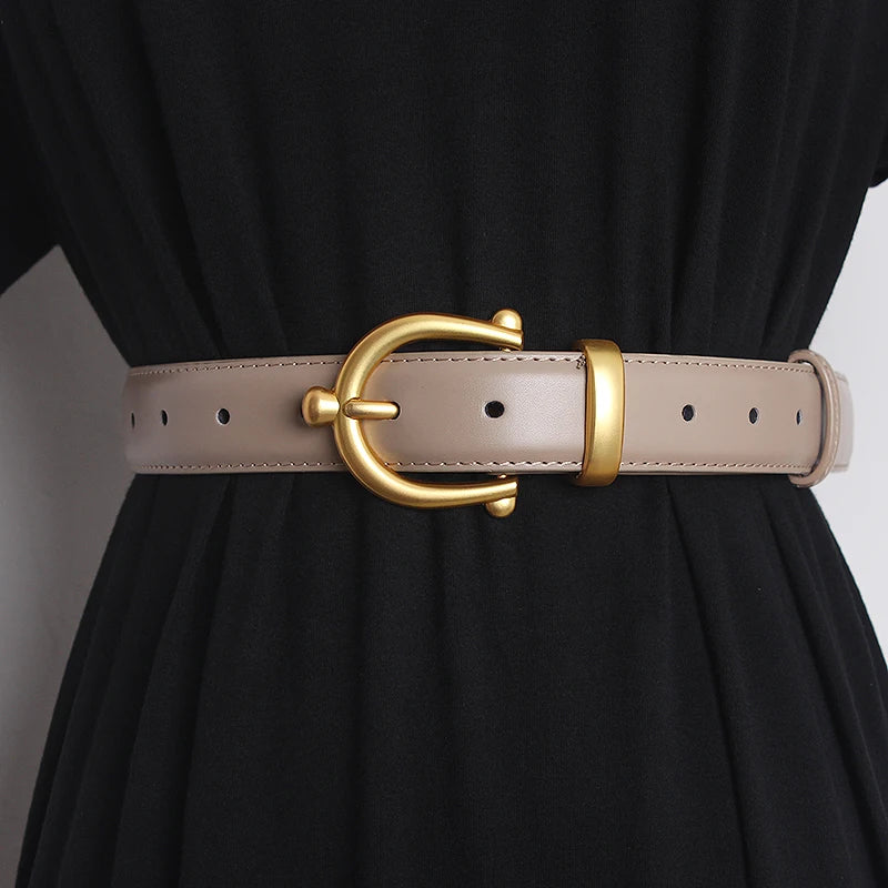 Light beige leather waist belt with gold-tone buckle ring and punched adjustment holes