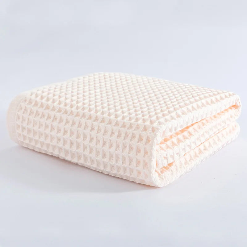 White waffle-knit cotton towel folded stack