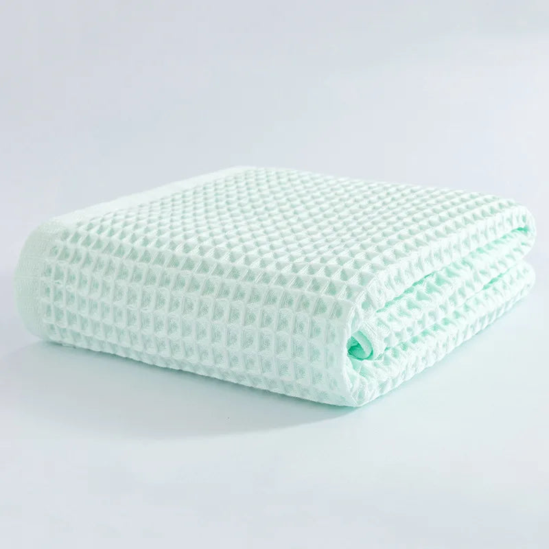 Soft cotton towel set, folded waffle-texture towels in light mint green