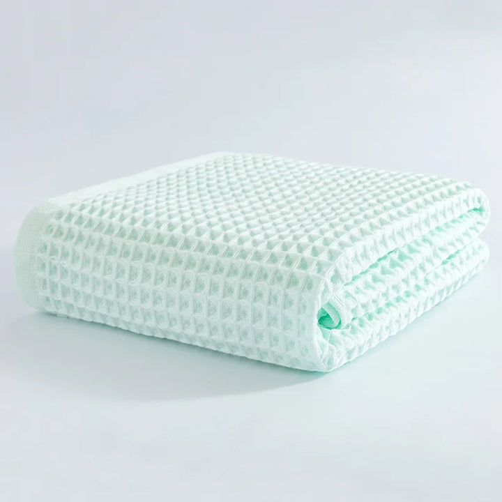 Soft cotton towel set, folded waffle-texture towels in light mint green