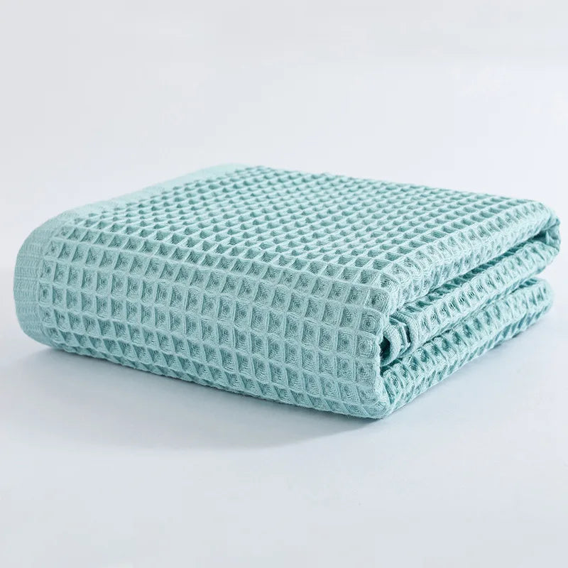 Light blue waffle-knit cotton towel folded stack