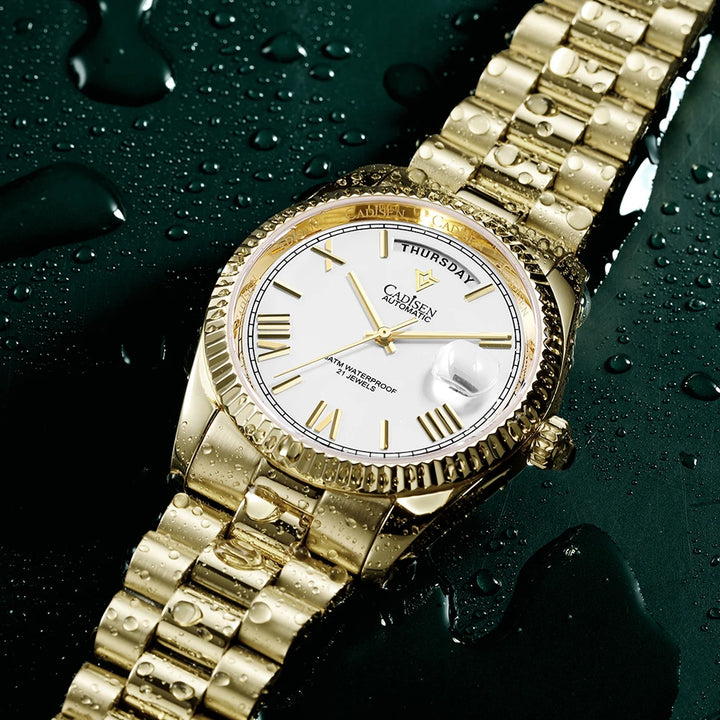 Gold-tone men’s automatic wrist watch with white dial and bracelet on water drops