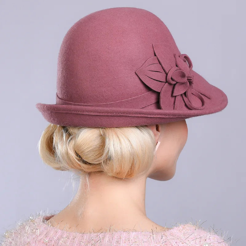 Plum wool pillbox hat with large fabric flower at the side