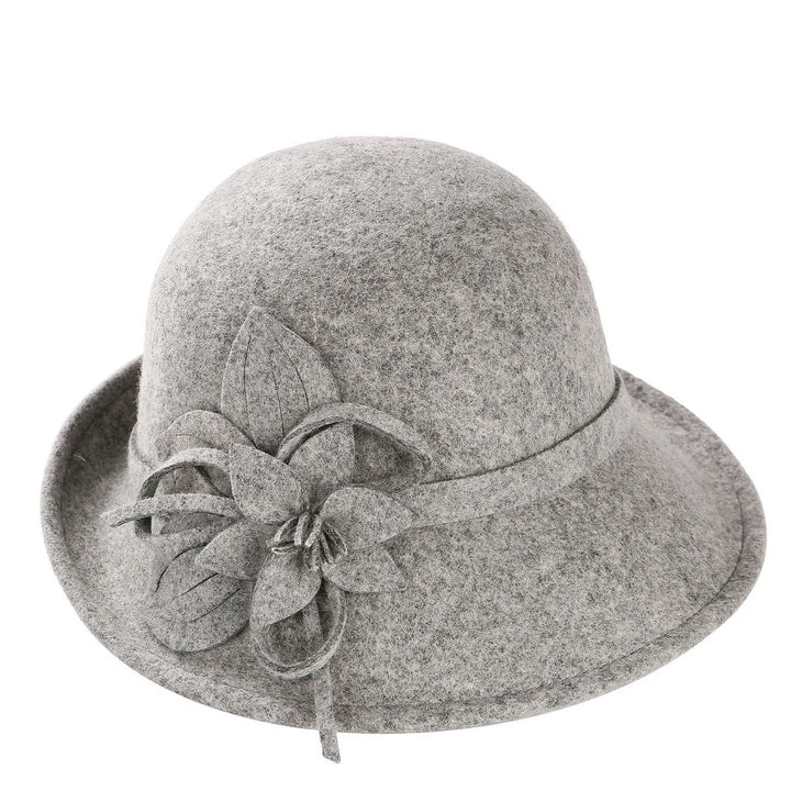 Gray wool pillbox hat with layered fabric flower and trailing bow detail