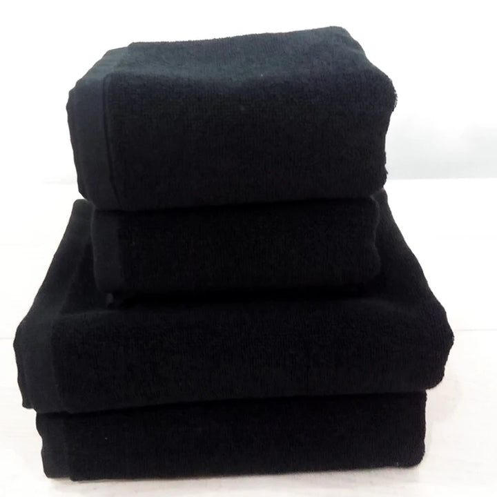 Black cotton face towels stacked, thick plush terry fabric