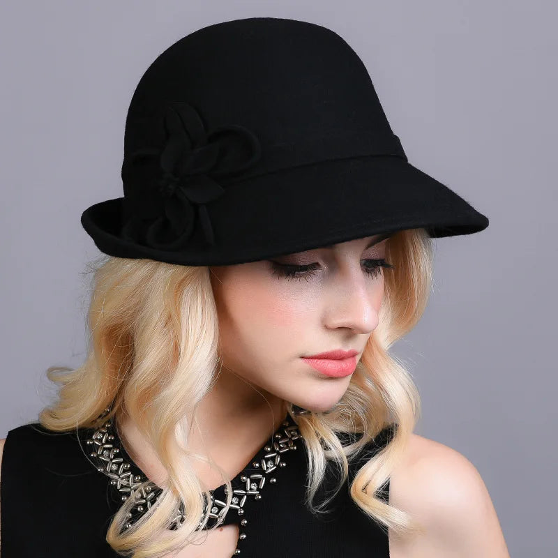 Black wool pillbox hat with side flower ornament