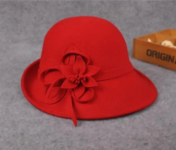 Red wool pillbox hat with bold fabric flower and leaf accents