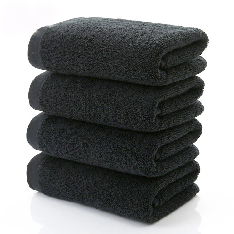 Black cotton face towels, stacked folded set with soft terry texture