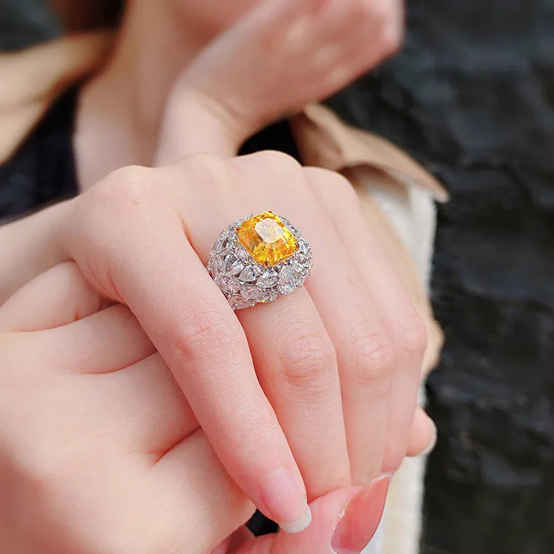 Gold filled crystal ring with yellow gemstone on a hand