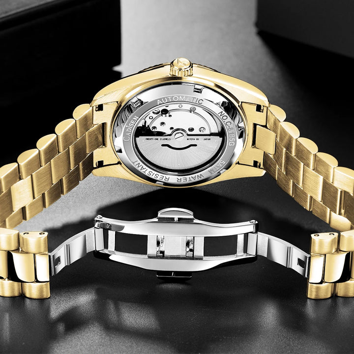 Gold-tone men’s automatic wrist watch with silver caseback and metal link bracelet