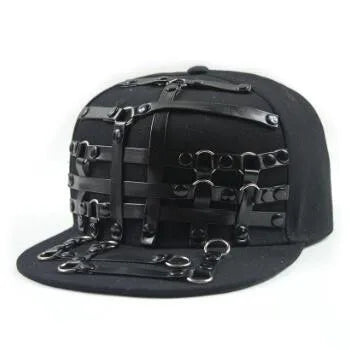 Black flat brim hat with layered bondage-style straps and metal ring embellishments