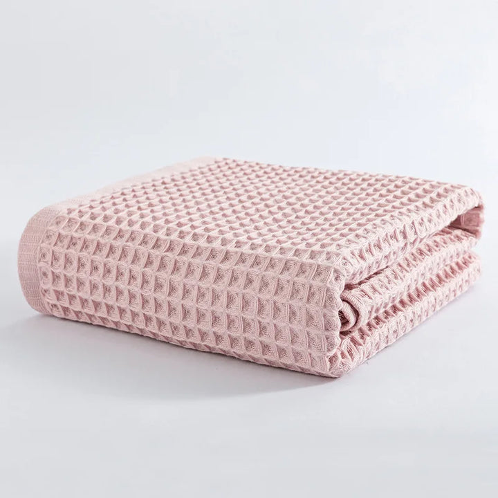 Pink waffle-knit cotton towel folded stack