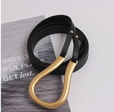 Wide belt with gold-tone heart buckle and black leather strap, metal eyelets