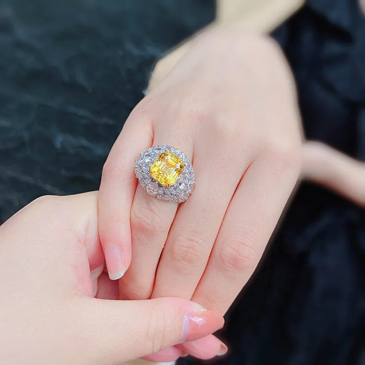 Silver-tone halo crystal ring with yellow square center gemstone, side view