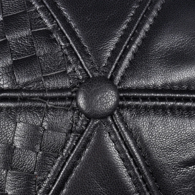 Black leather woven cap crown close-up with central seam and button