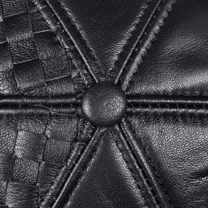 Black leather woven cap crown close-up with central seam and button