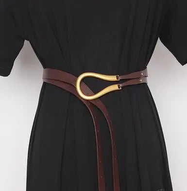 Women’s wide leather belt on dress form with gold oval buckle, dark brown and black