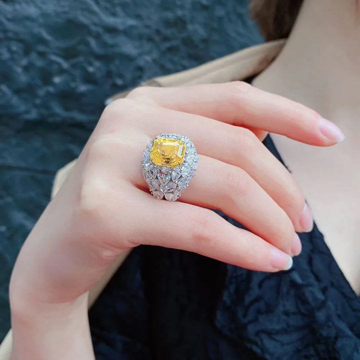 Yellow square gemstone crystal ring with bright clear halo on finger