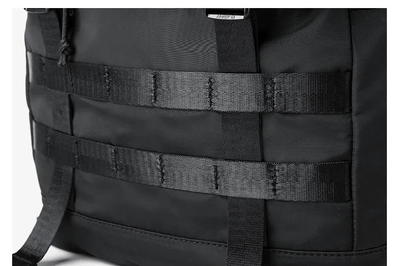 Black expandable roll-top rucksack with multifunction front strap webbing
