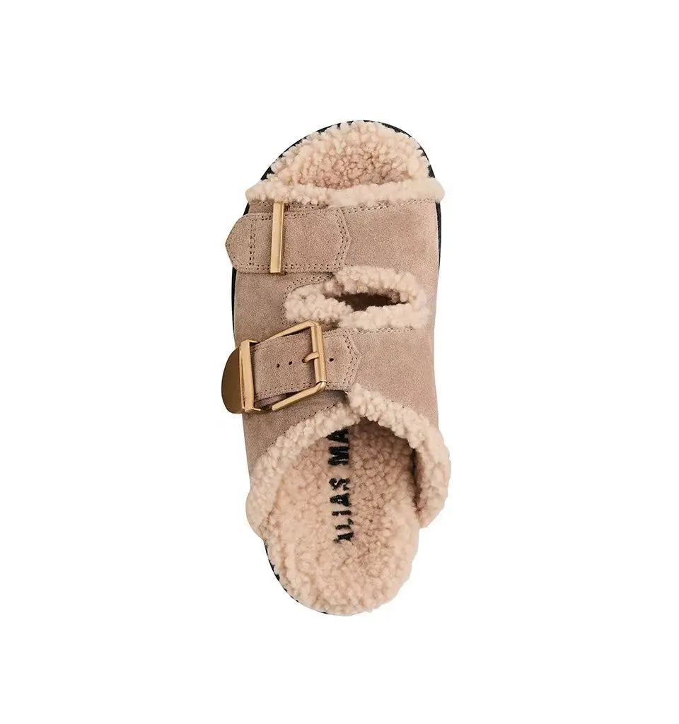 Dog boot with fur lining and buckle on a white background