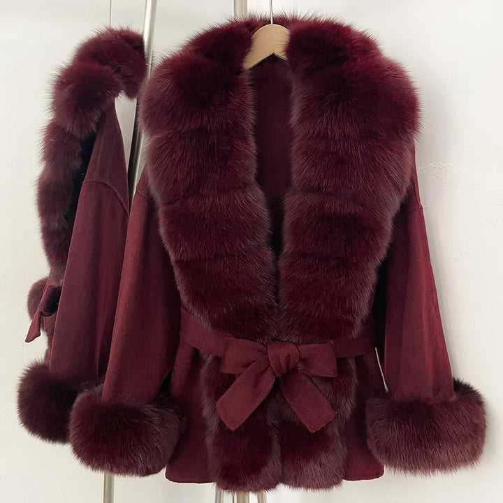 Burgundy coat with faux fur yoke and sleeves, wide lapels, and bow tie waist belt