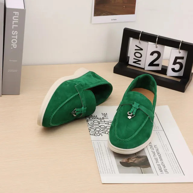 Green suede slip-on loafers with metal buckle and moc toe stitching